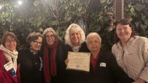 Alameda Post - A group of six women smile, pose together, and hold a certificate.
