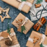 Alameda Post - Packages wrapped in brown paper and string with pinecones, cinnamon sticks, and wooden details.