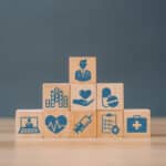 Alameda Post - Building blocks with healthcare symbols like medication and a doctor.