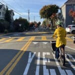 Alameda Post - A bicyclist approaches a traffic circle in a neighborhood greenway.
