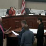Alameda Post - Several people stand at the front of an AUSD Board meeting with Ryan LaLone swears in.