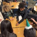Alameda Post - A group of elementary students build a structure out of toothpicks or sticks on top of their desks.