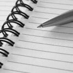 Alameda Post - a pen on an open lined notebook.