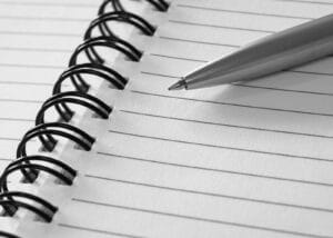 Alameda Post - a pen on an open lined notebook.