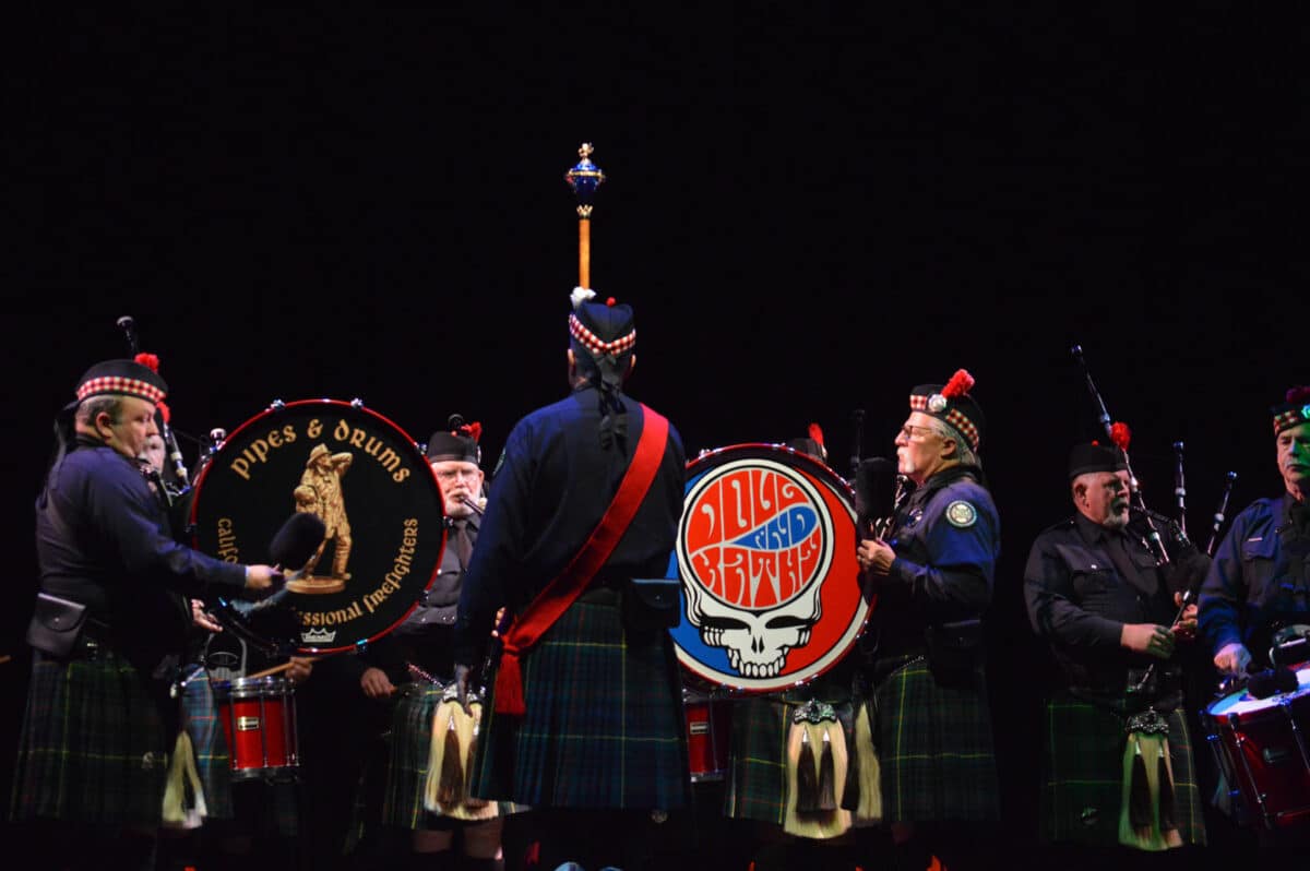 Alameda Post - A pipe and drum band perform in kilts onstage.