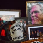 Alameda Post - A memorial display with photographs and an Alameda Captain of the Fire Department helmet.
