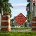 Alameda Post - A photo of traffic markers and a sign that says Road Work Ahead.