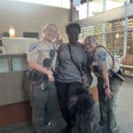 Alameda Post - a photo of two animal control officers and a citizen with a freshly groomed poodle.