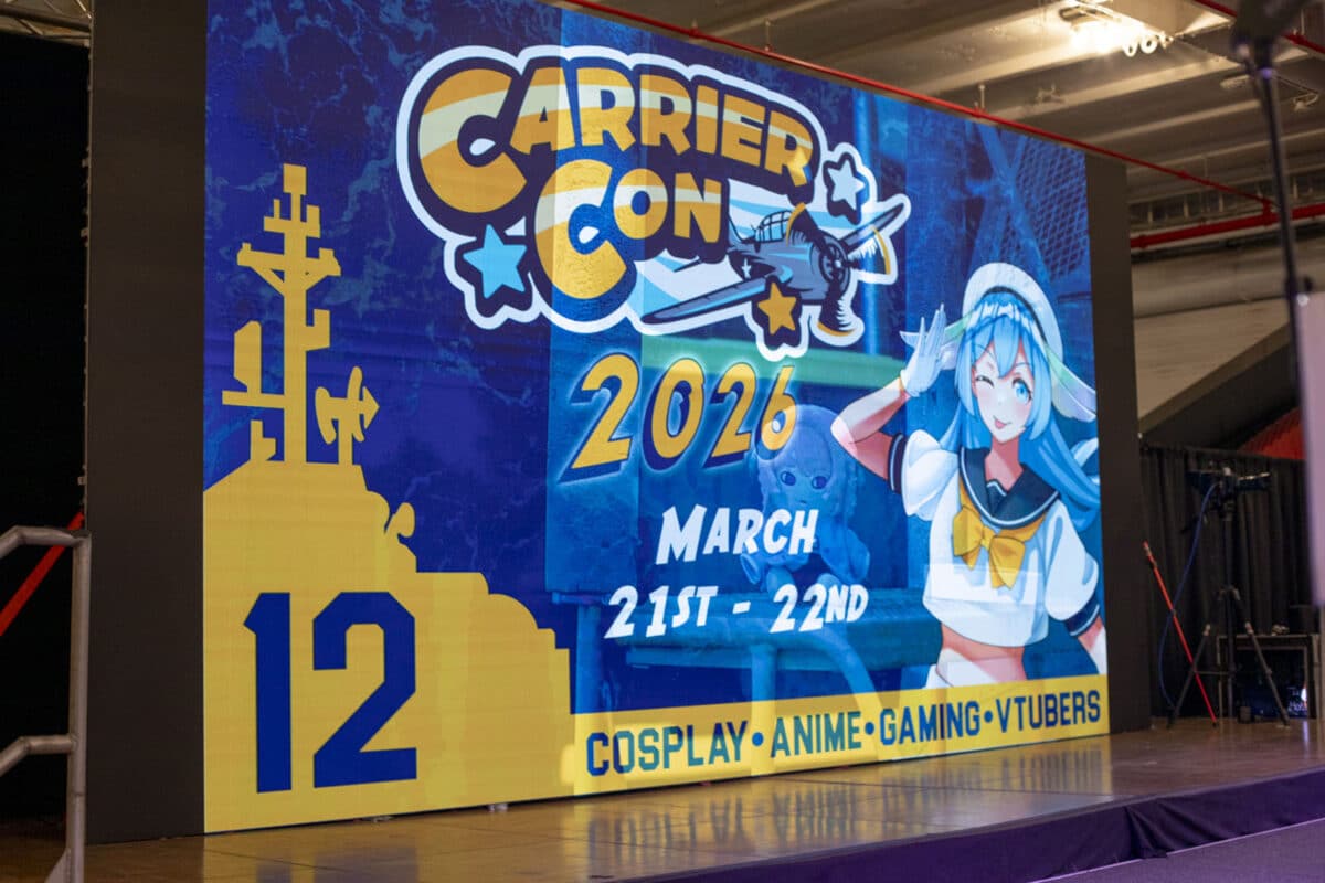 Alameda Post - A projection with the poster for CarrierCon 2026 aboard the ship.