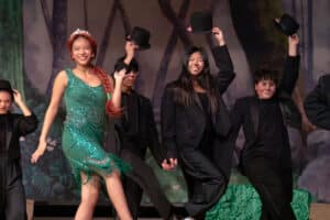 Alameda Post - Fiona dances with ensemble members in top hats.