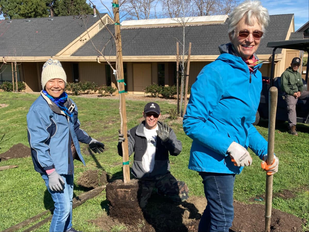 Alameda Post - Volunteers smile while planting trees at Leydecker Park. 