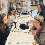 Alameda Post - Four elementary schoolers and one adult sit around a table with podcast equipment. They are recording the February Little Minds Big Talks podcast.