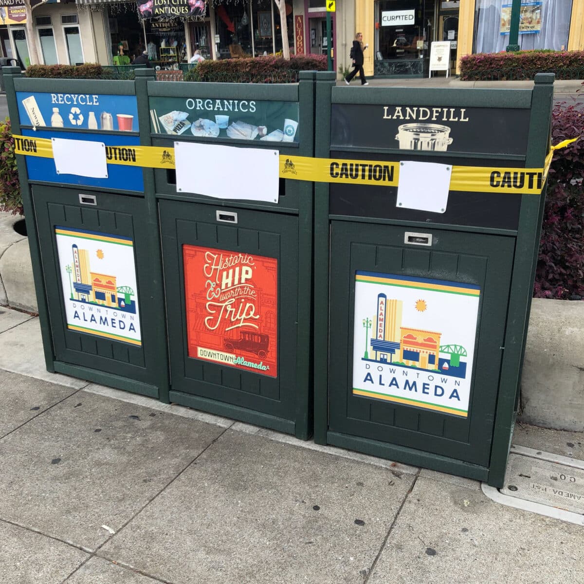 Alameda Post - Garbage, compost, and recycling cans that are roped off. 