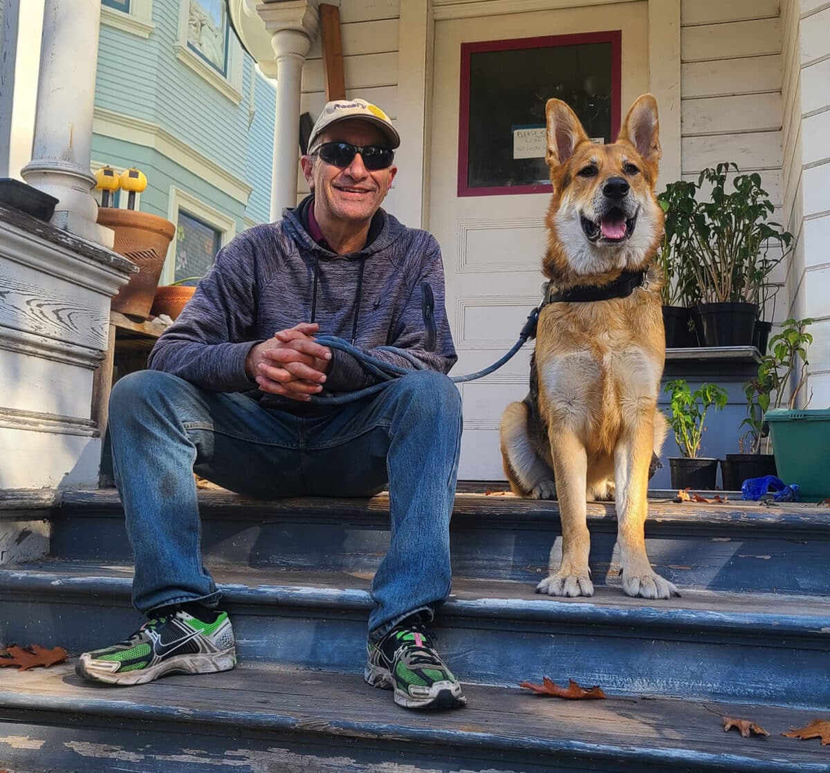 Alameda Post - Jeff and Mouf pose together on the steps of a home. 