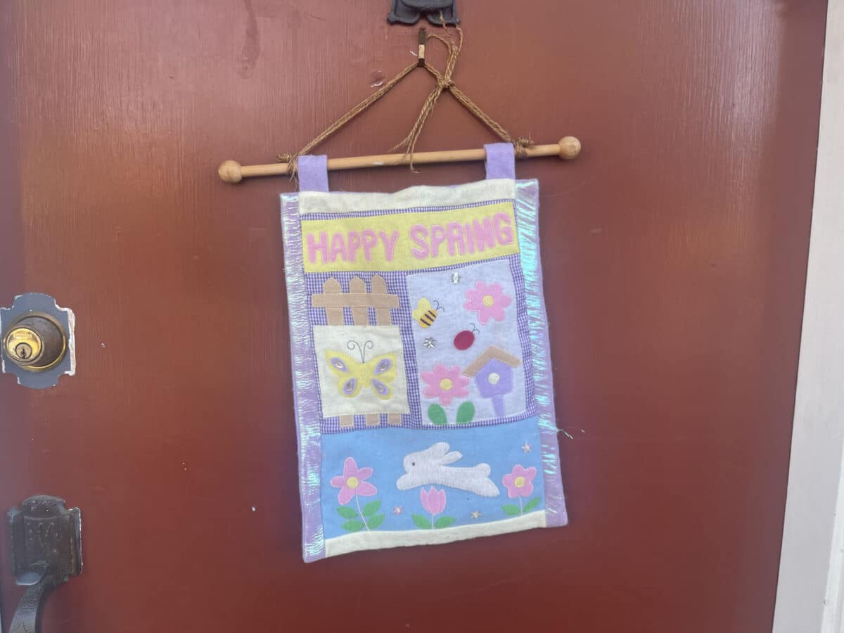 Alameda Post - A decorative door hanger that says "Happy Spring."