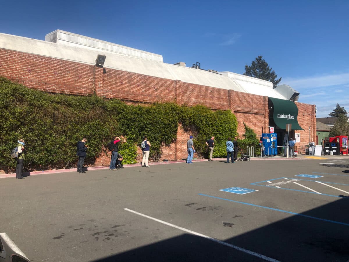 Alameda Post - A line of people out of the Alameda Natural Grocery store.
