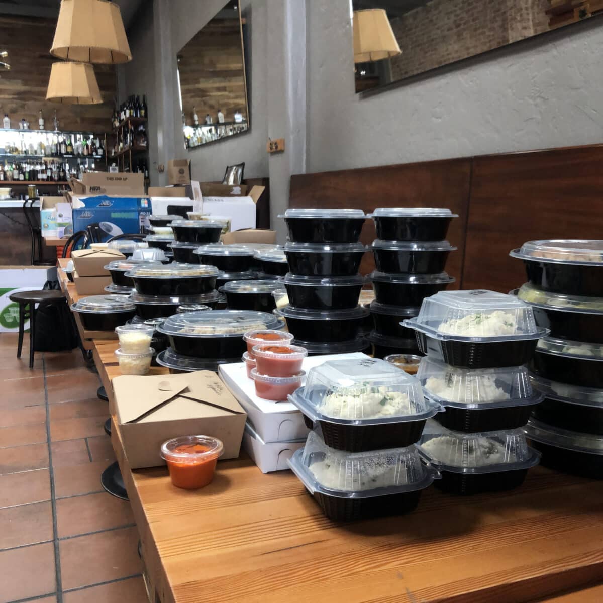 Alameda Post - A pile of to-go containers at a restaurant. 