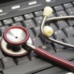 Alameda Post - A stethoscope on top of a keyboard.