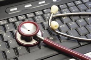 Alameda Post - A stethoscope on top of a keyboard.