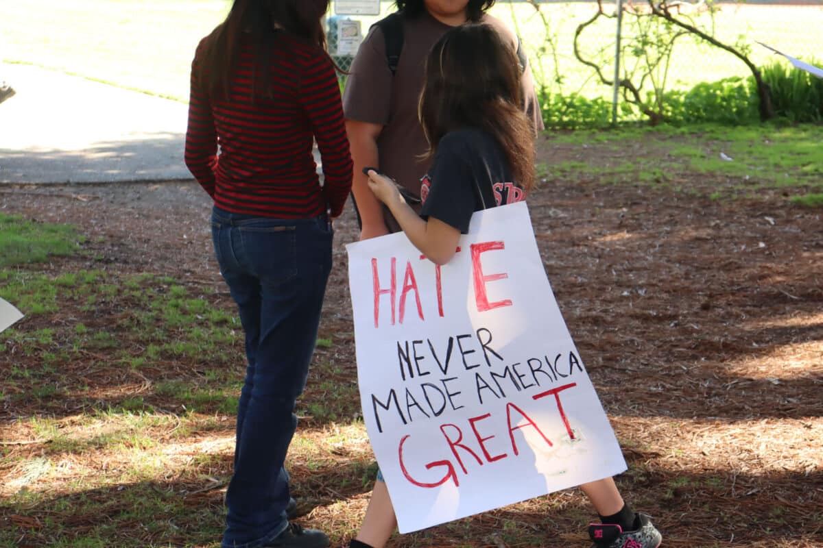 Alameda Post - A teenager holds a sign that says "Hate never made America great"