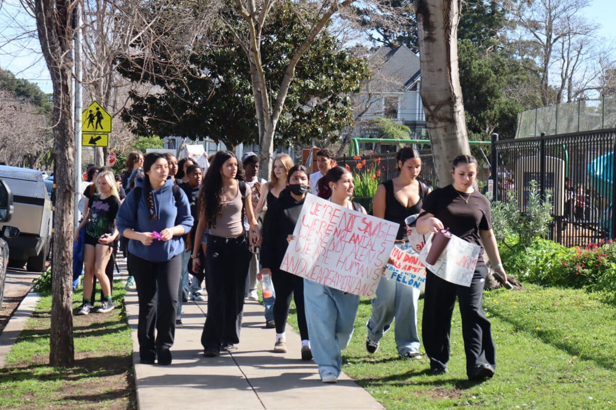 Alameda Post - students march with protest signs. 