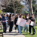 Alameda Post - students march with protest signs.