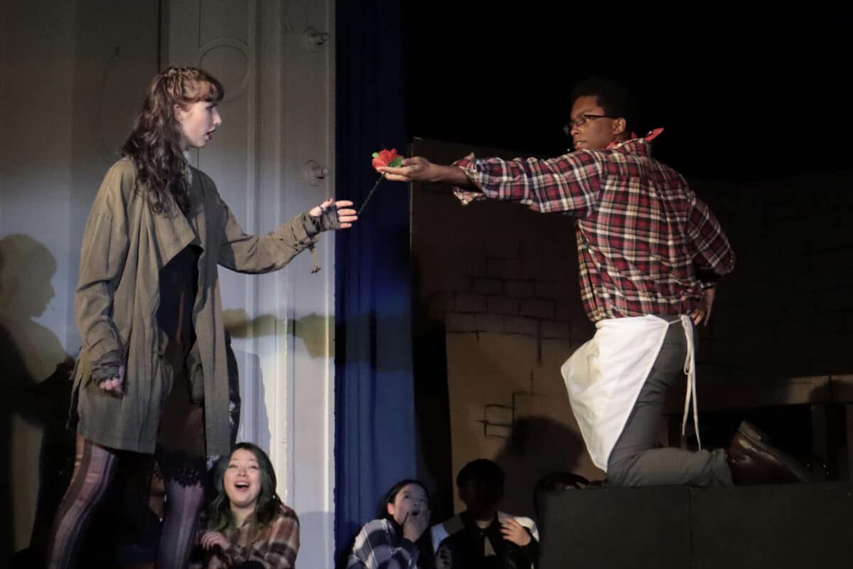 Alameda Post - An actor hands a rose to an actress onstage.