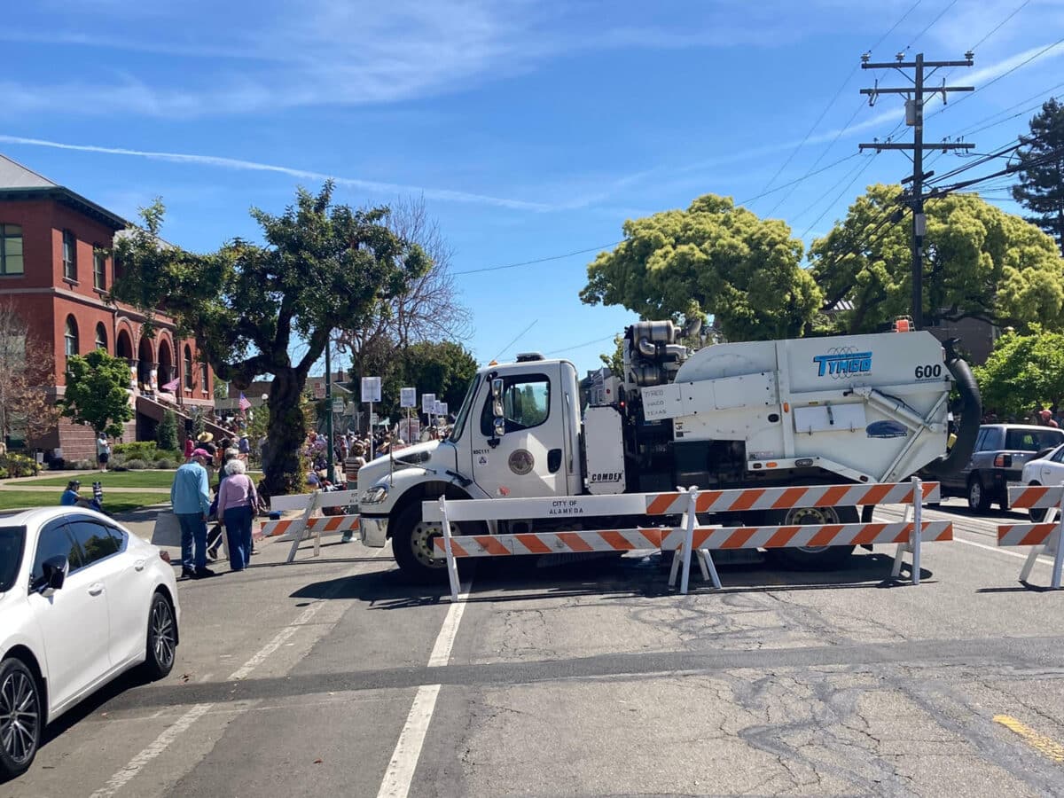 Alameda Post - A street sweeper parked blocking the No Kings protest.