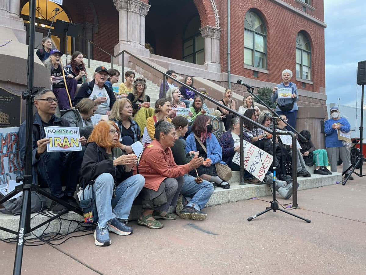 Alameda Post - "No Wary on Iran" Rallygoers sit on the steps of Alameda City Hall.
