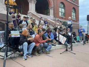 Alameda Post - "No Wary on Iran" Rallygoers sit on the steps of Alameda City Hall.