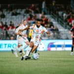 Alameda Post - An Oakland Roots player dribbles the ball in a match against Phoenix Rising.