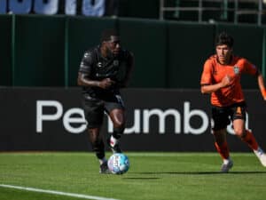 Alameda Post - An Oakland Roots player dribbles the ball in a match against Orange County SC.