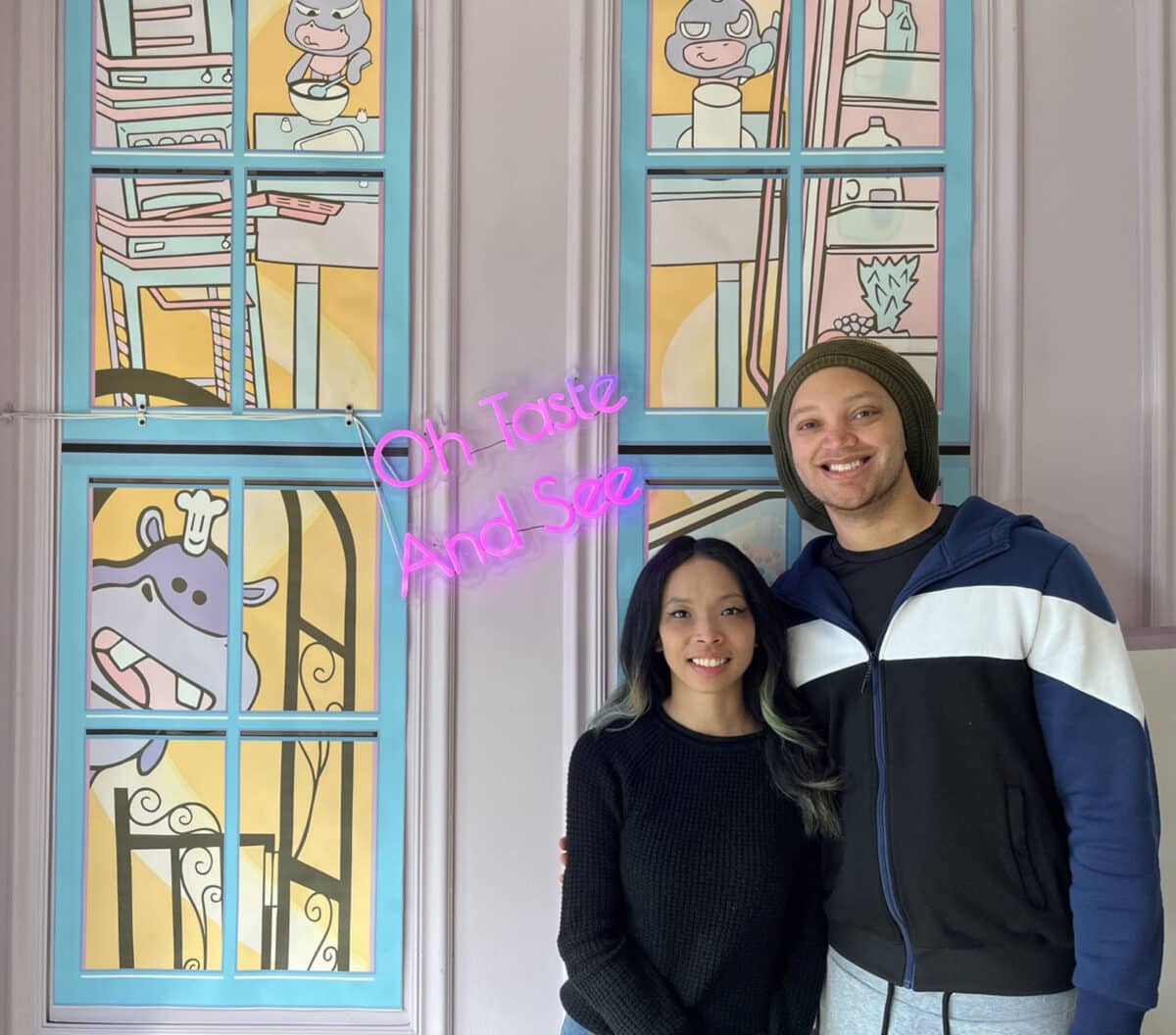 Alameda Post - a smiling couple inside a backdrop at Doodlecakes. 
