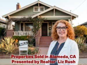 Alameda Post - A red haired woman smiles in front of a home that has a sold sign in the yard.