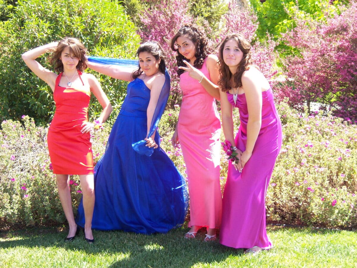 Four friends taking photos before prom. 