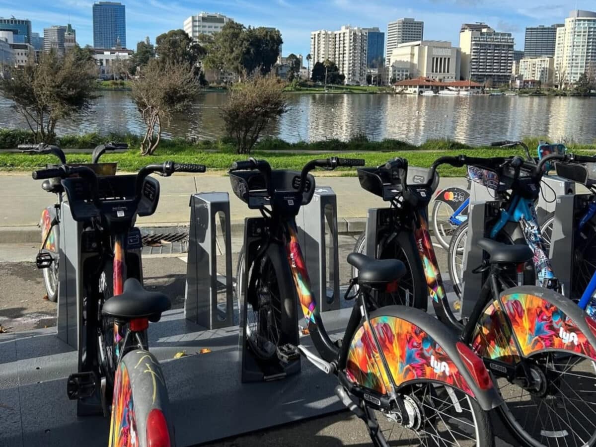 Alameda Post - A bike rack full of bike share bicycles overlooking Lake Merritt.