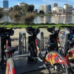 Alameda Post - A bike rack full of bike share bicycles overlooking Lake Merritt.