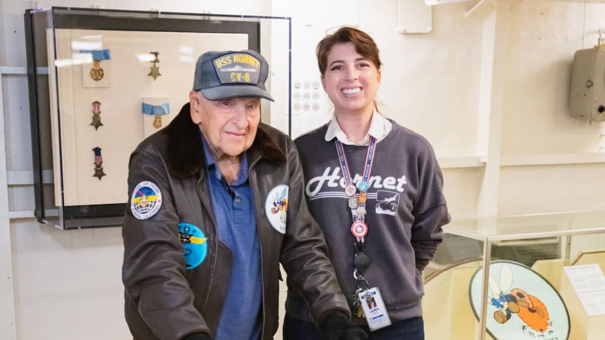 Alameda Post - Alfred J. Payne stands with a smiling woman wearing a lanyard.