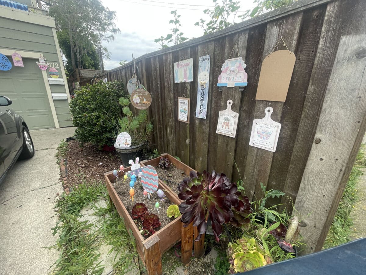 Alameda Post - Easter signs and decor hanging on a fence and placed in a raised garden bed.