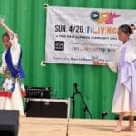 Alameda Post - A photo of two young girls dancing on a stage.