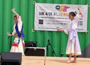 Alameda Post - A photo of two young girls dancing on a stage.