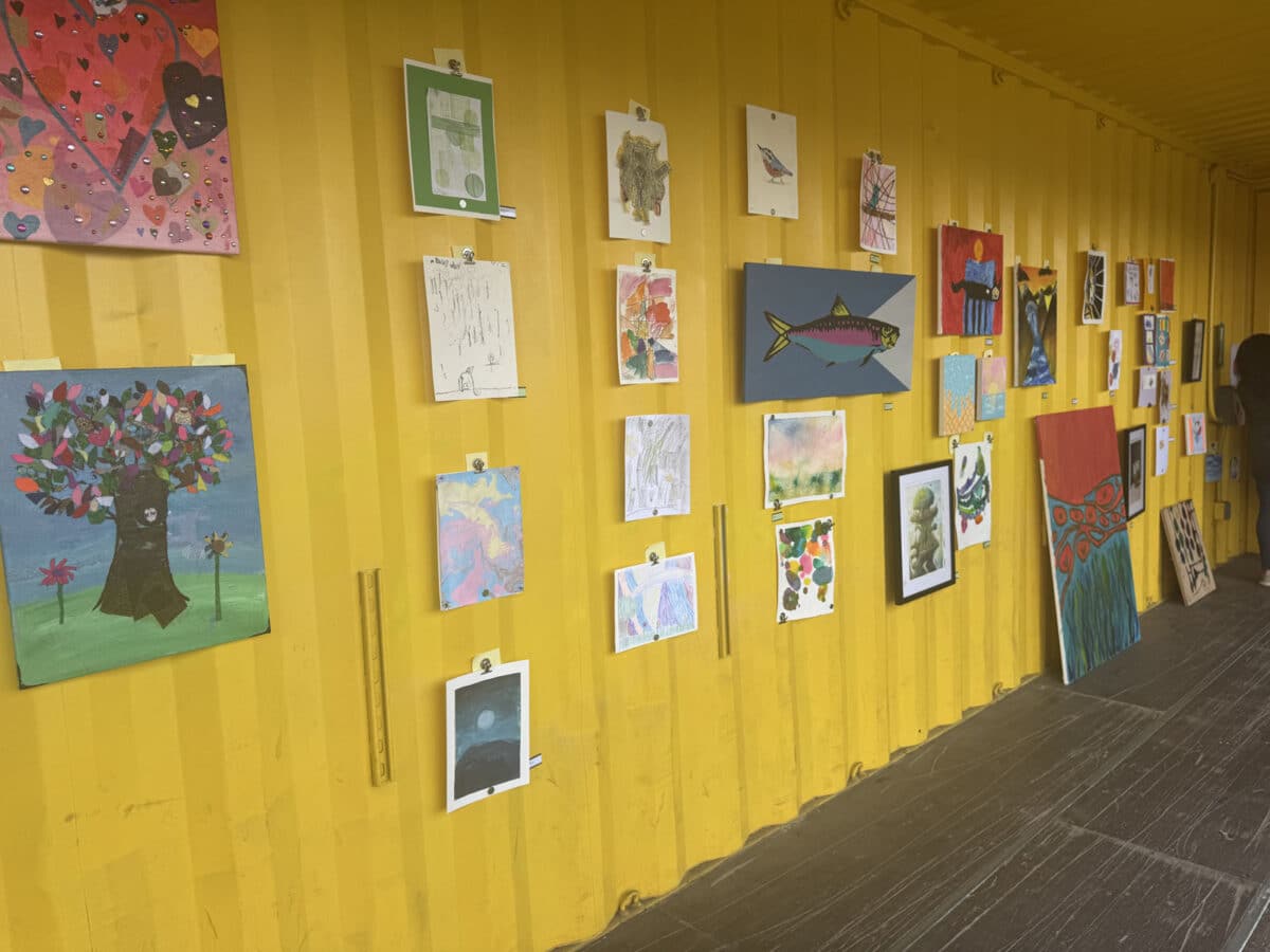 Alameda Post - Artwork hung on the side of a bright yellow shipping container at the In Living Color festival.