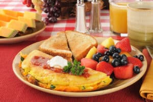 Alameda Post - A brunch plate with an omelette, toast, and fruit.
