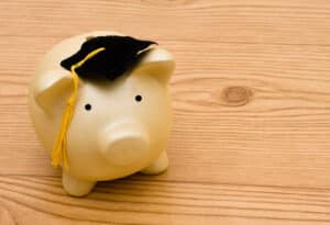 Alameda Post - A piggy bank with a graduation cap.