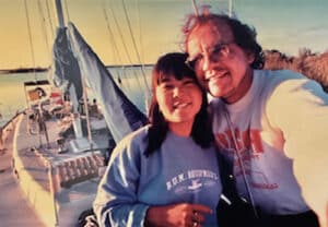 Alameda Post - A man and a woman smile at the camera, taking a selfie on a boat.