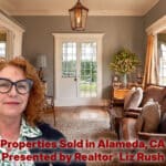 Alameda Post - A red haired woman smiles the living room of a home for sale.