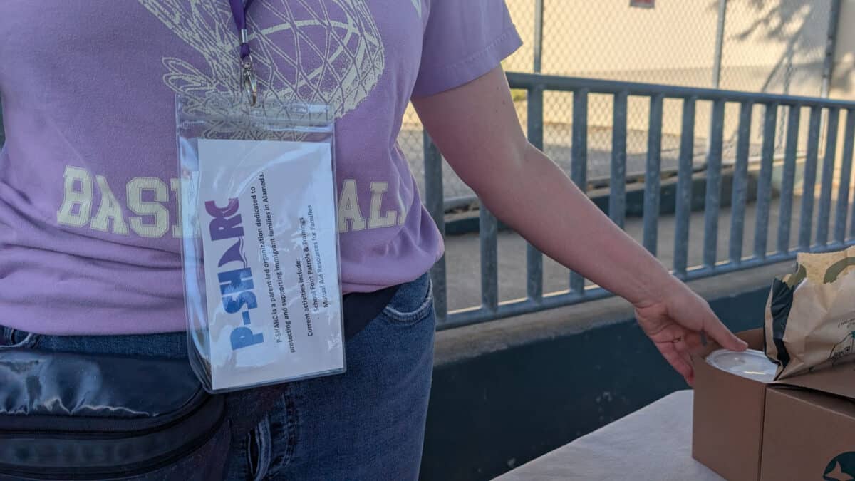 Alameda Post - A woman wears a P. S.H.A.R.C. bagge.