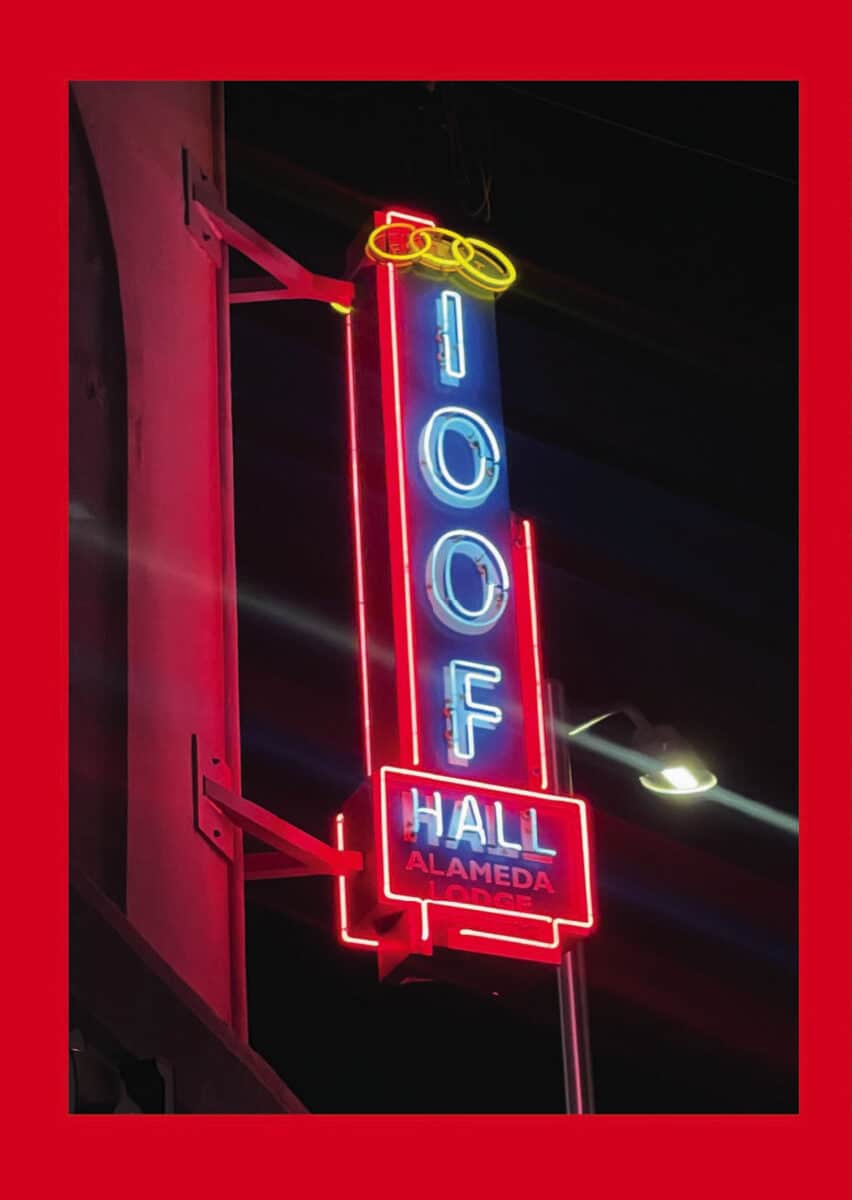 Alameda Post - A multicolored neon sign at night that says I.O.O.F. Hall Alameda.