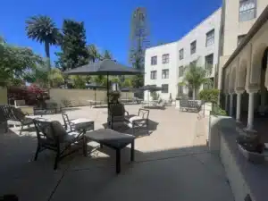 Alameda Post - An outdoor patio with beach chairs and umbrellas at the Alameda Hotel.