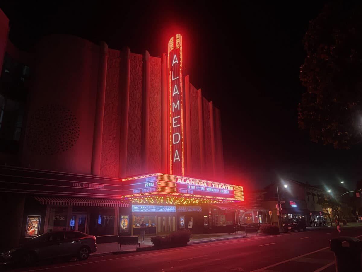 Alameda Post - the Alameda Theatre and Cineplex neon sign lit up brightly at night.